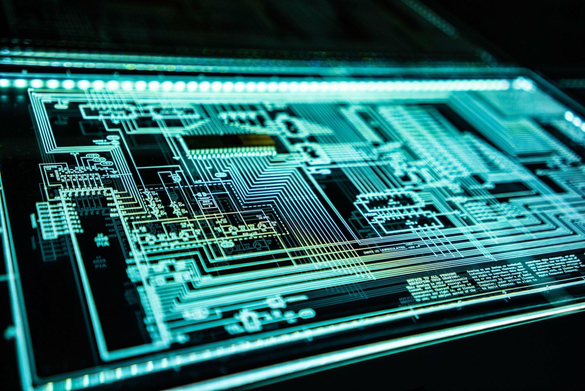 Circuit board with digital data flow depicted in neon blue, representing cybersecurity.