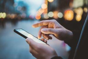 Hands holding a phone that displays a website built with  a SEO company.