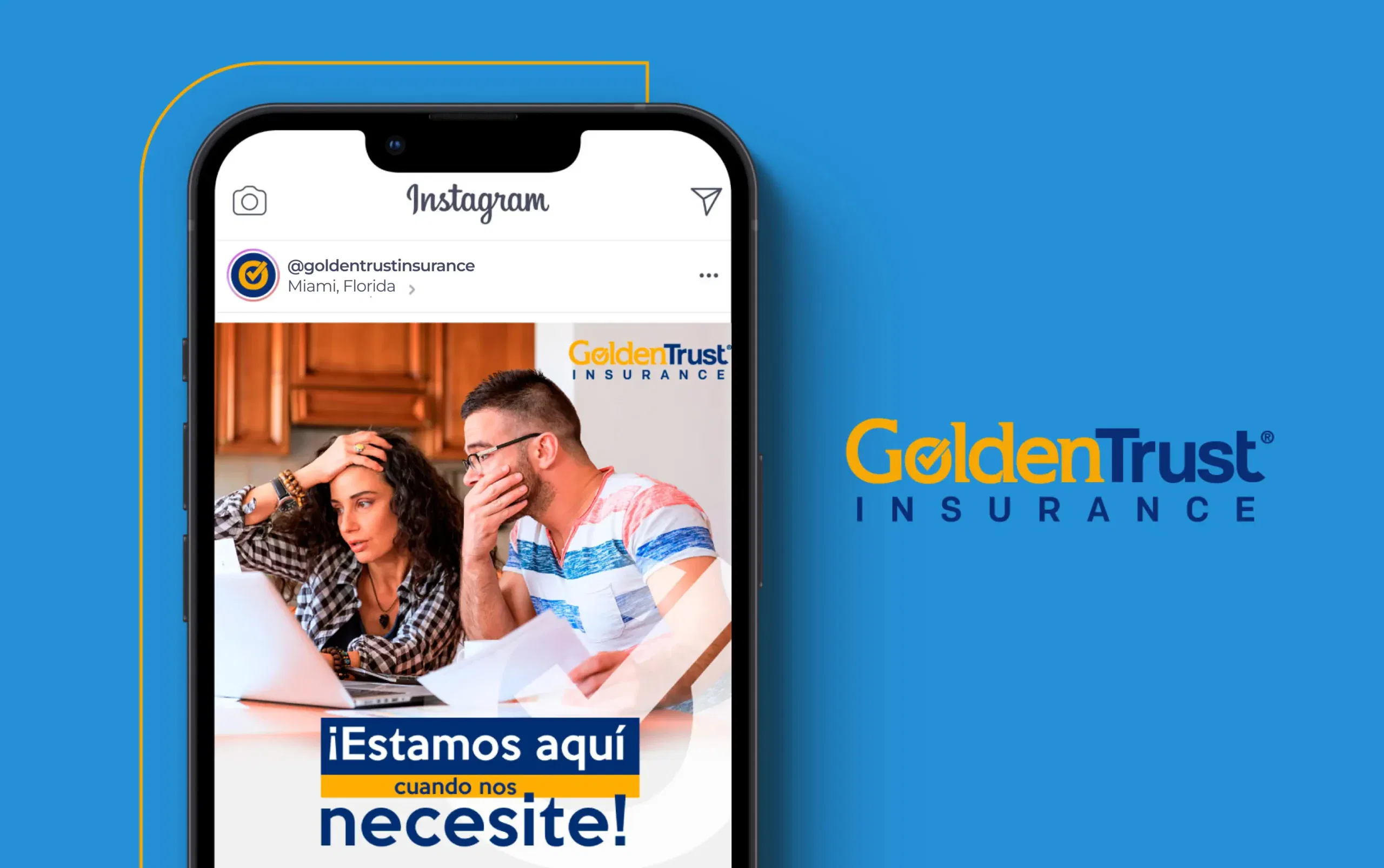 Couple reviewing documents with Golden Trust Insurance logo on a phone screen.