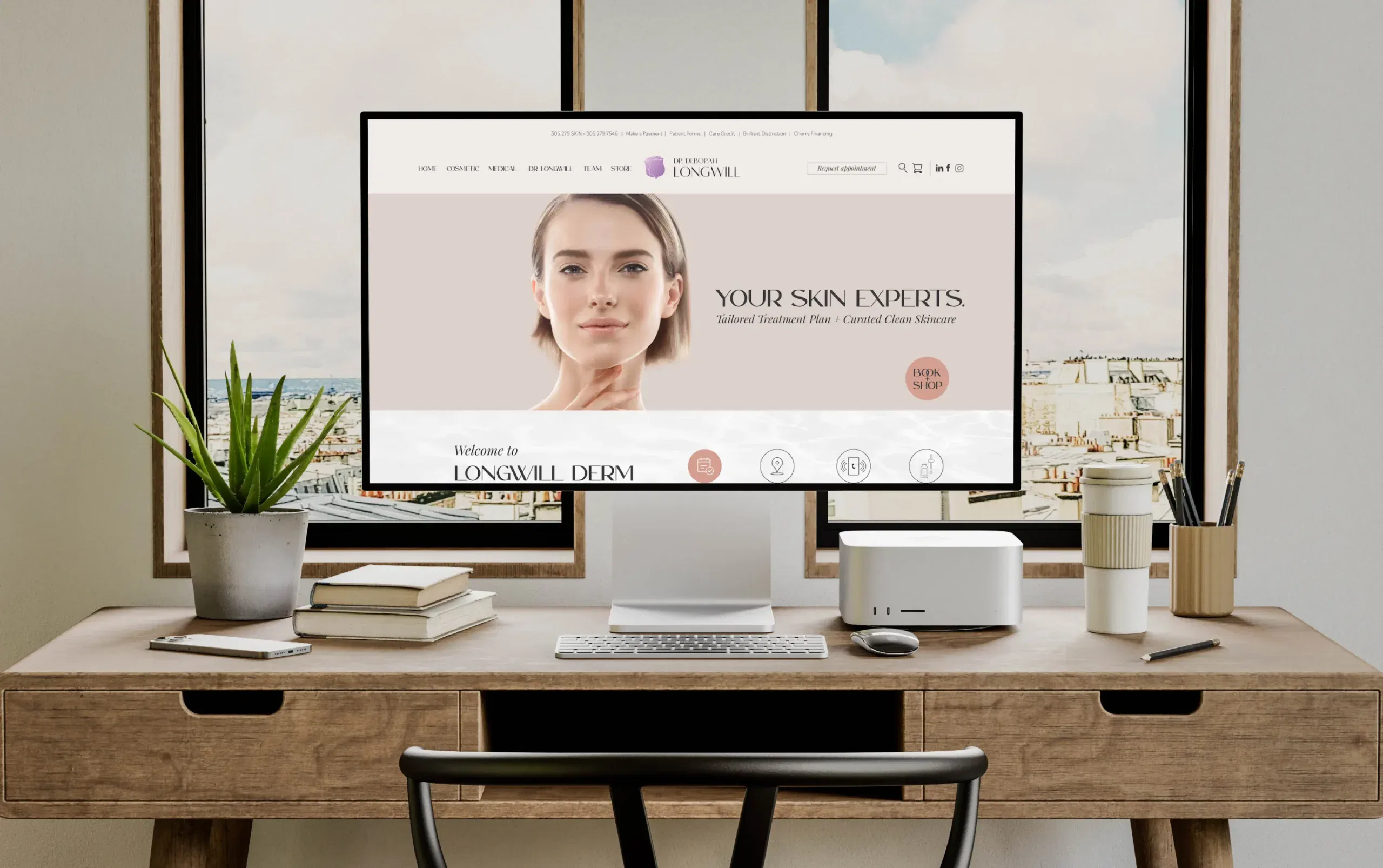 Modern workspace featuring a computer monitor displaying a skincare website with a serene city view.