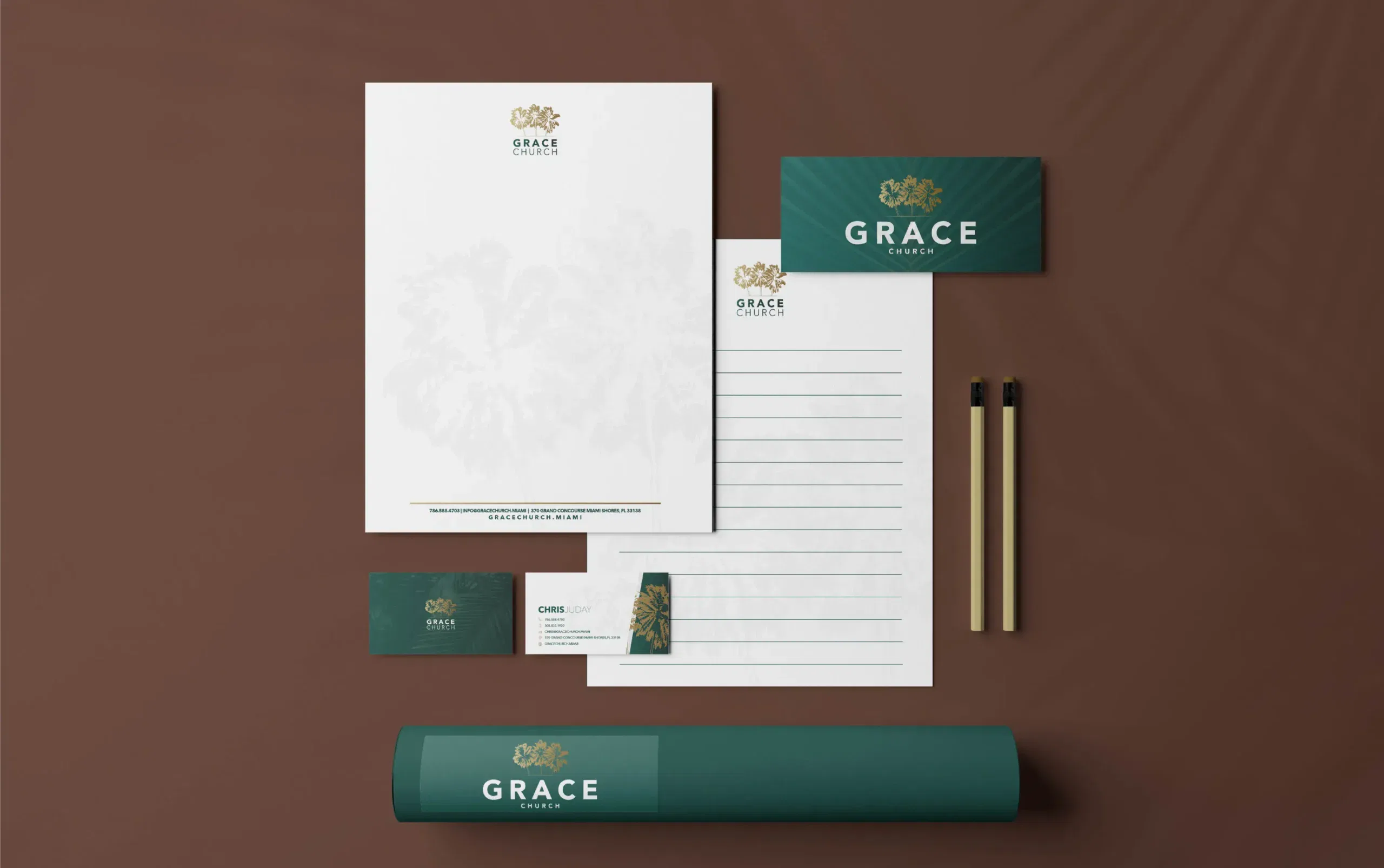 Elegant stationery set with green branding and gold lettering on a brown backdrop.