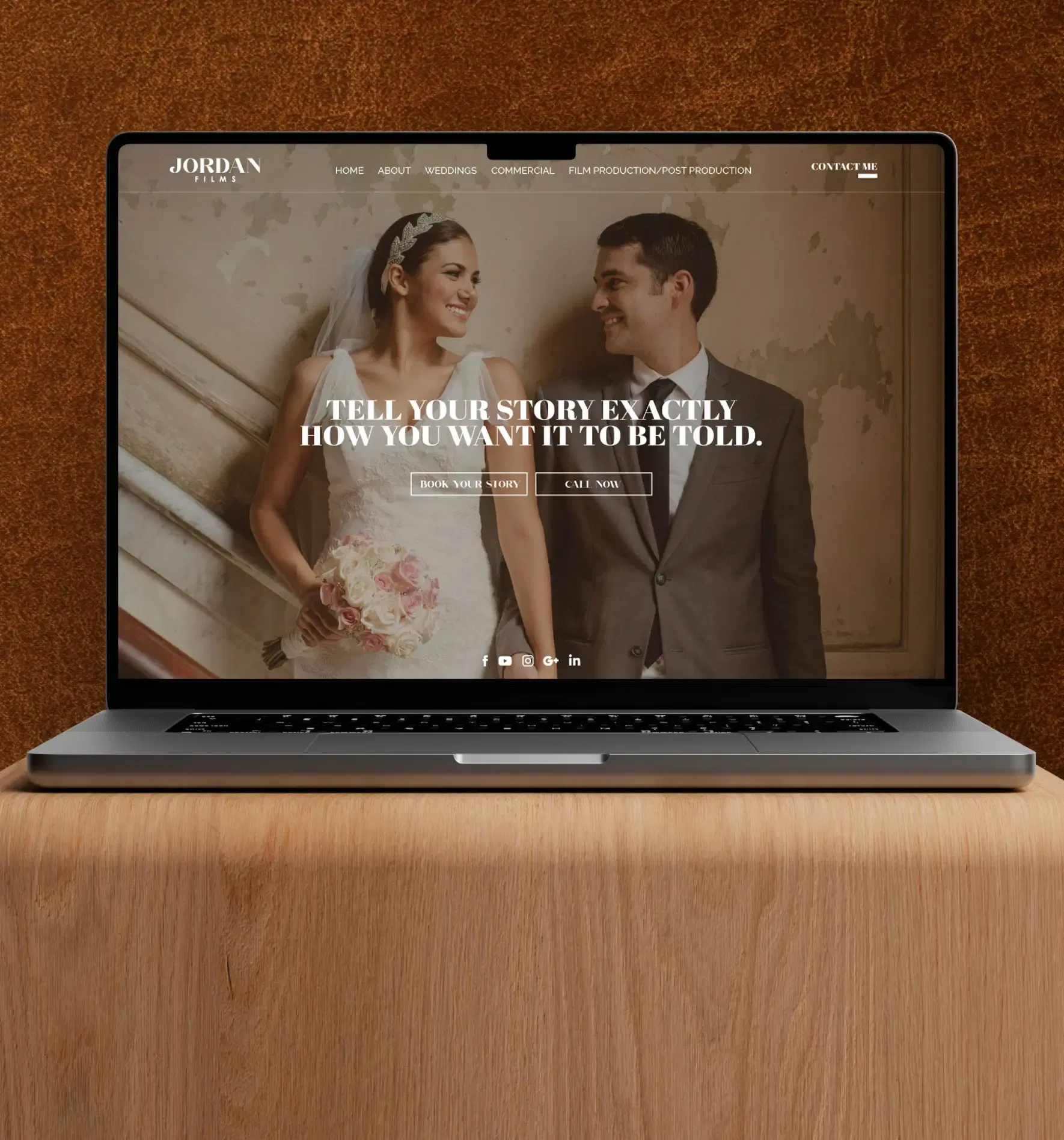 Laptop displaying a wedding website with a smiling couple on the screen.