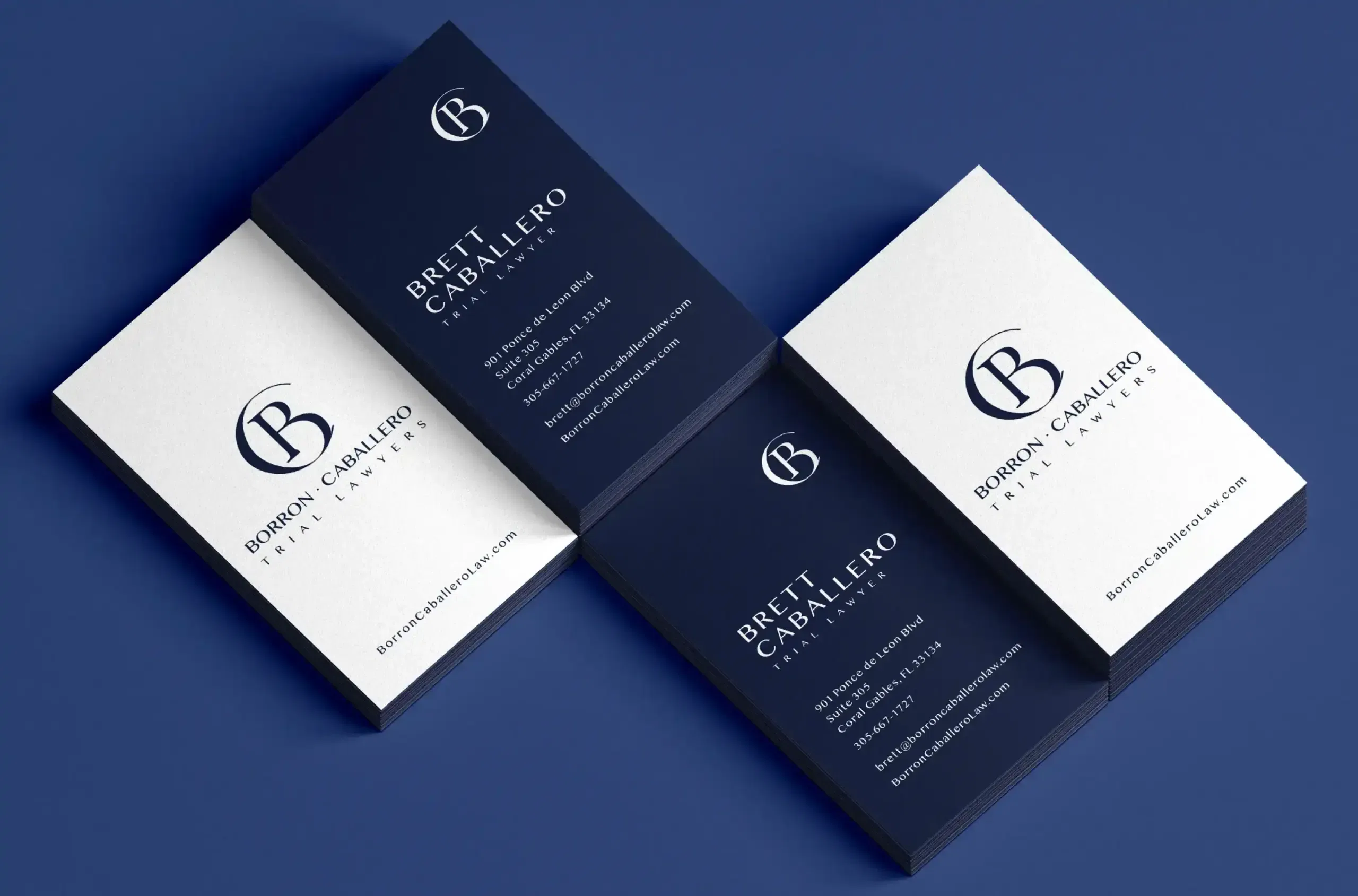 Elegant navy and white business cards arranged on a blue surface.