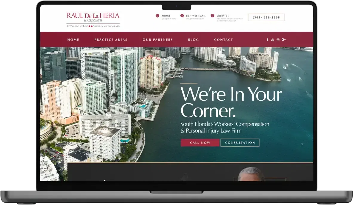 Laptop displaying a law firm's website with an urban skyline background.