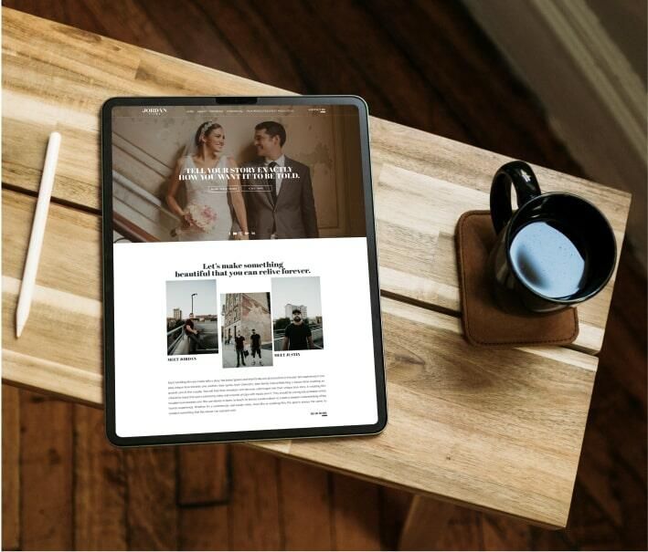 Tablet on a wooden table displaying a wedding website next to a stylus and a cup of coffee.