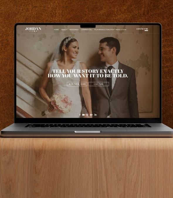 Laptop displaying a wedding photography website featuring a smiling bride and groom.