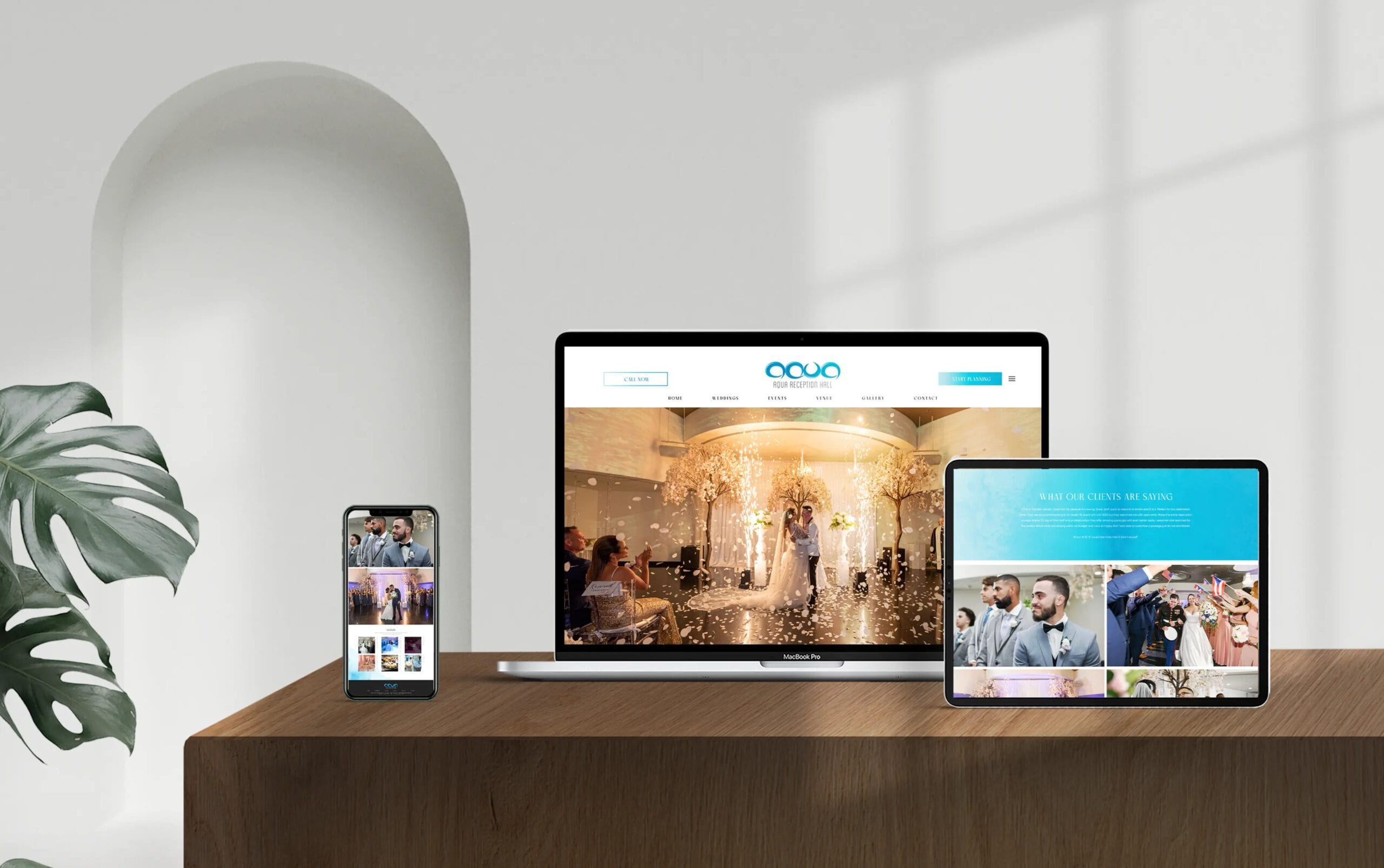 Various devices displaying a responsive business website setup on a sleek wooden desk.