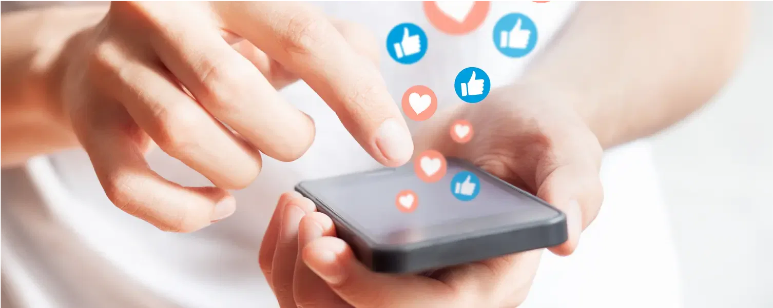 Hands engaging with social media likes and hearts on a smartphone.