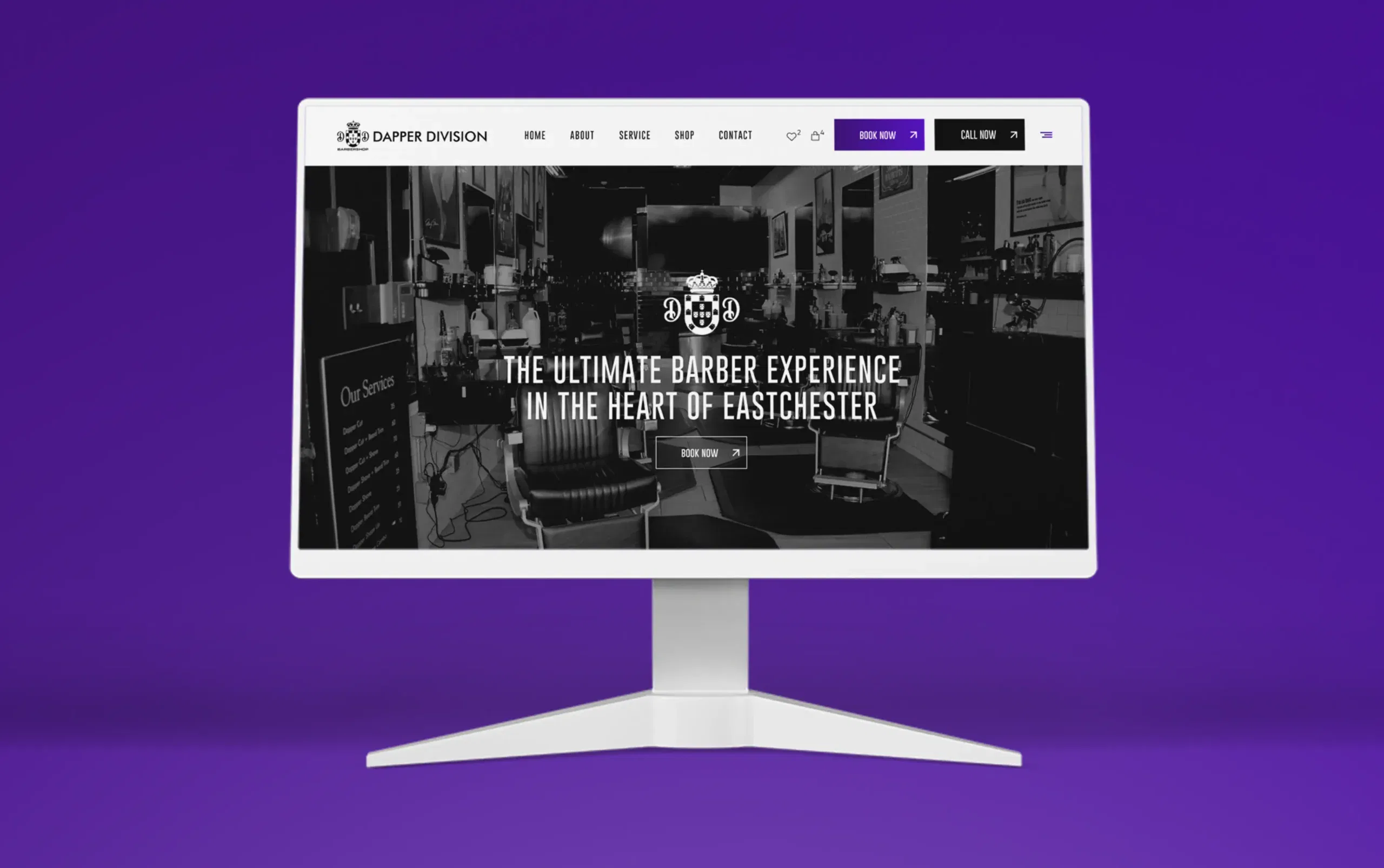 Modern computer monitor displaying a sleek barber shop website with a purple background.