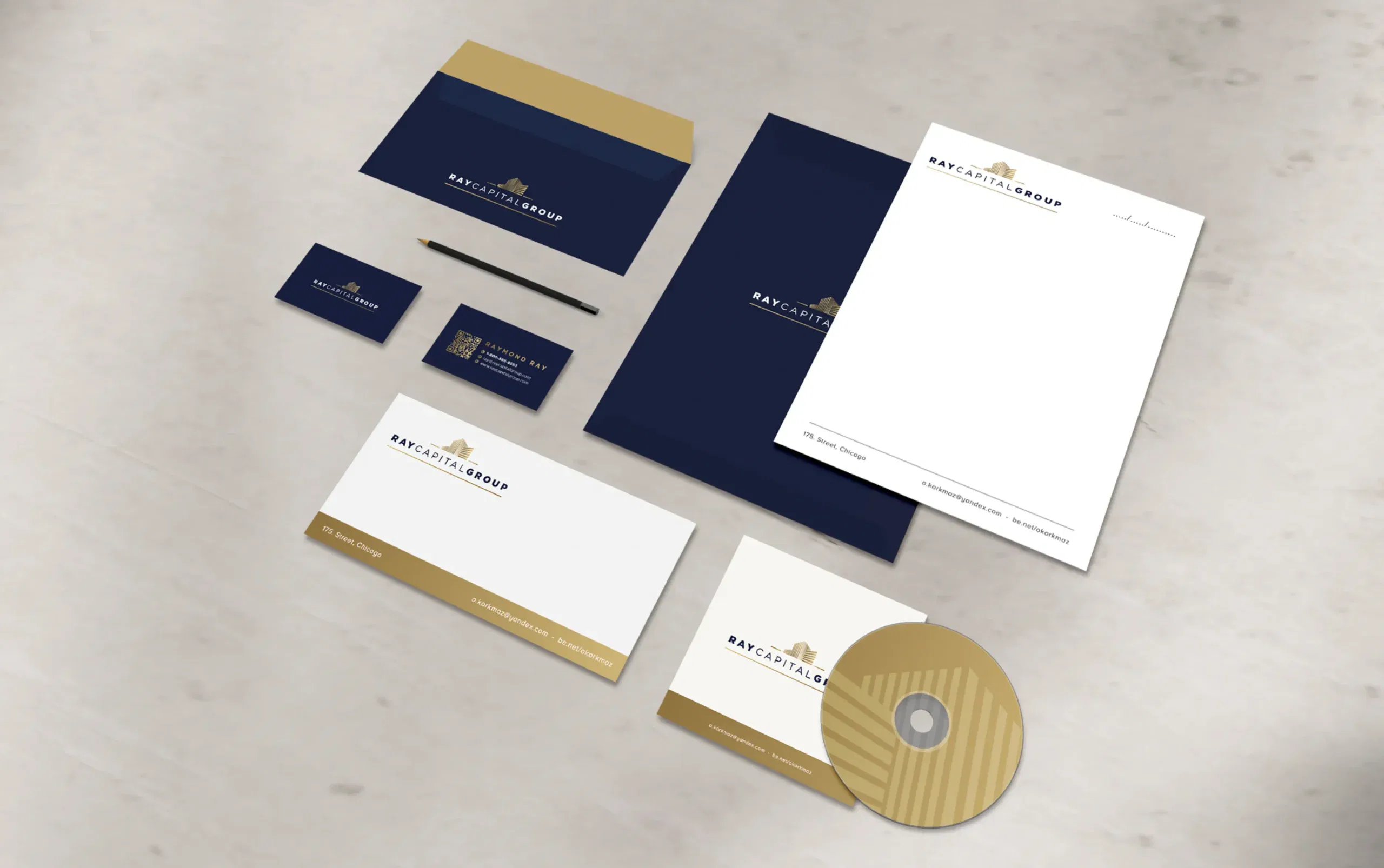 Professional stationery set with navy and gold accents, including letterhead, envelope, business cards, and a CD.