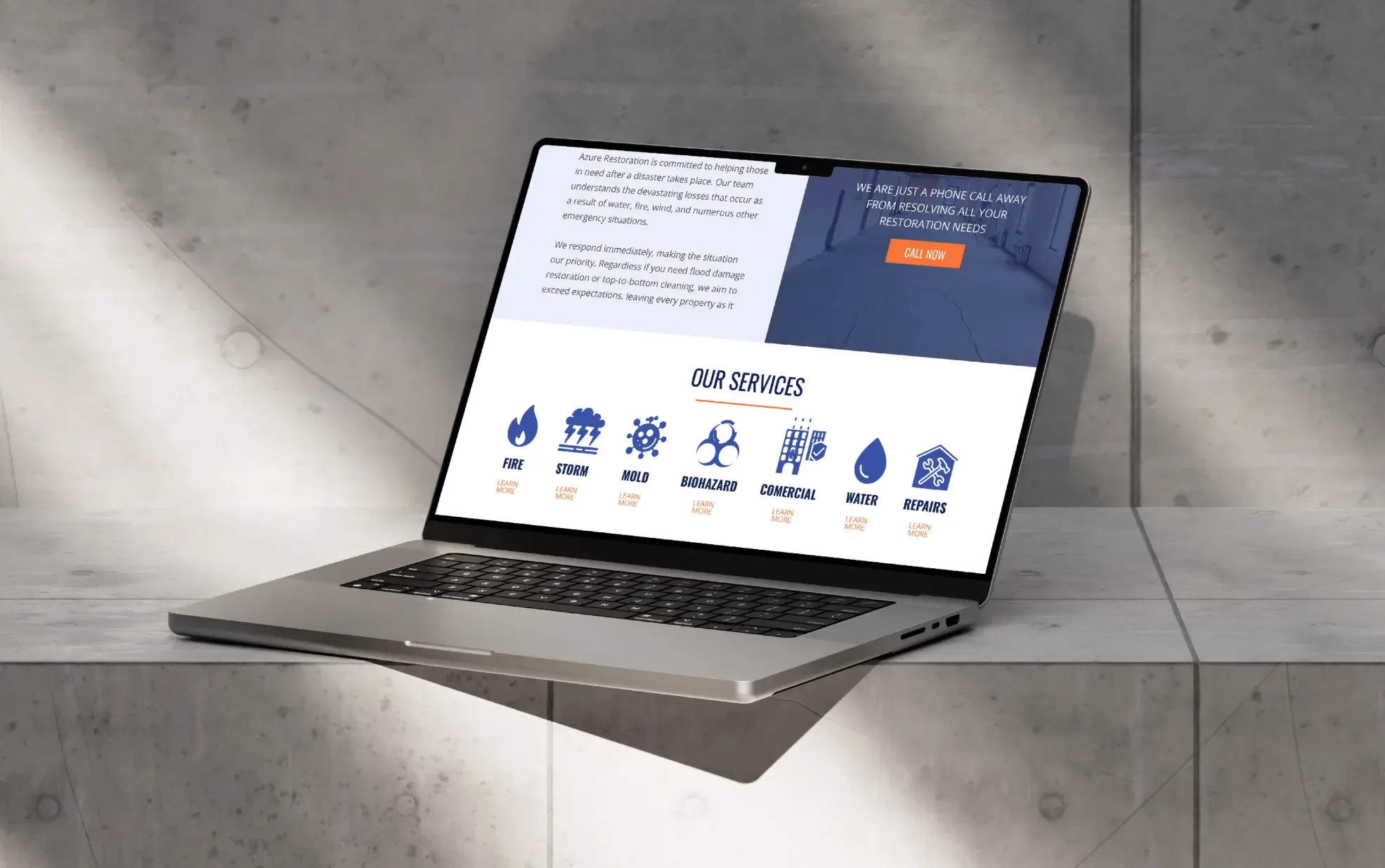 Open laptop displaying a website with various service icons, placed on a sunlit stone surface.