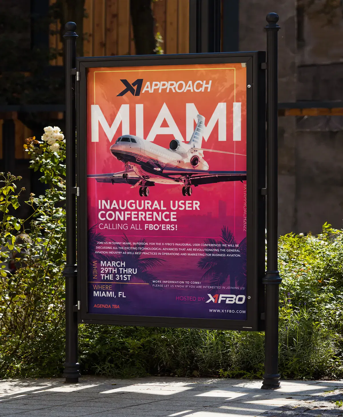 Outdoor advertisement for Miami user conference featuring airplane graphic and event details.