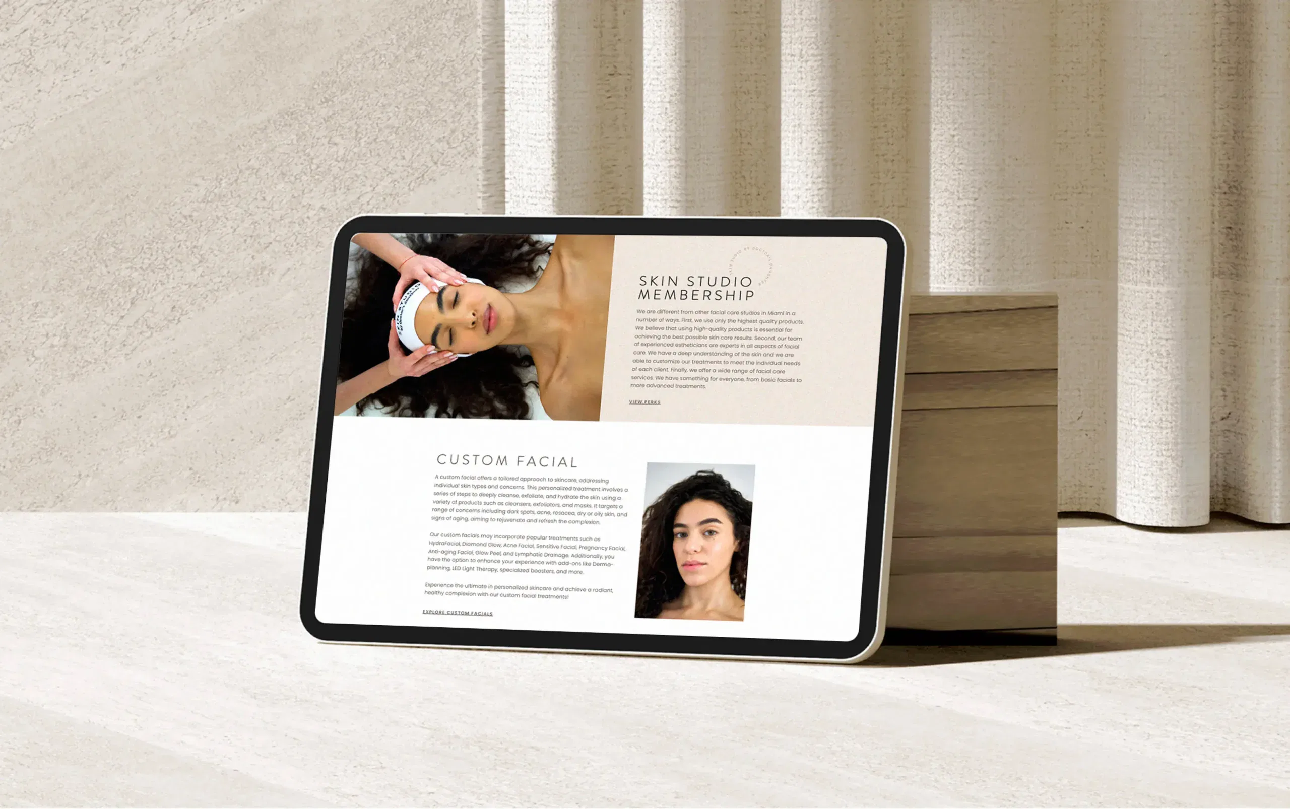 Tablet displaying skincare article, propped on books against a neutral background.
