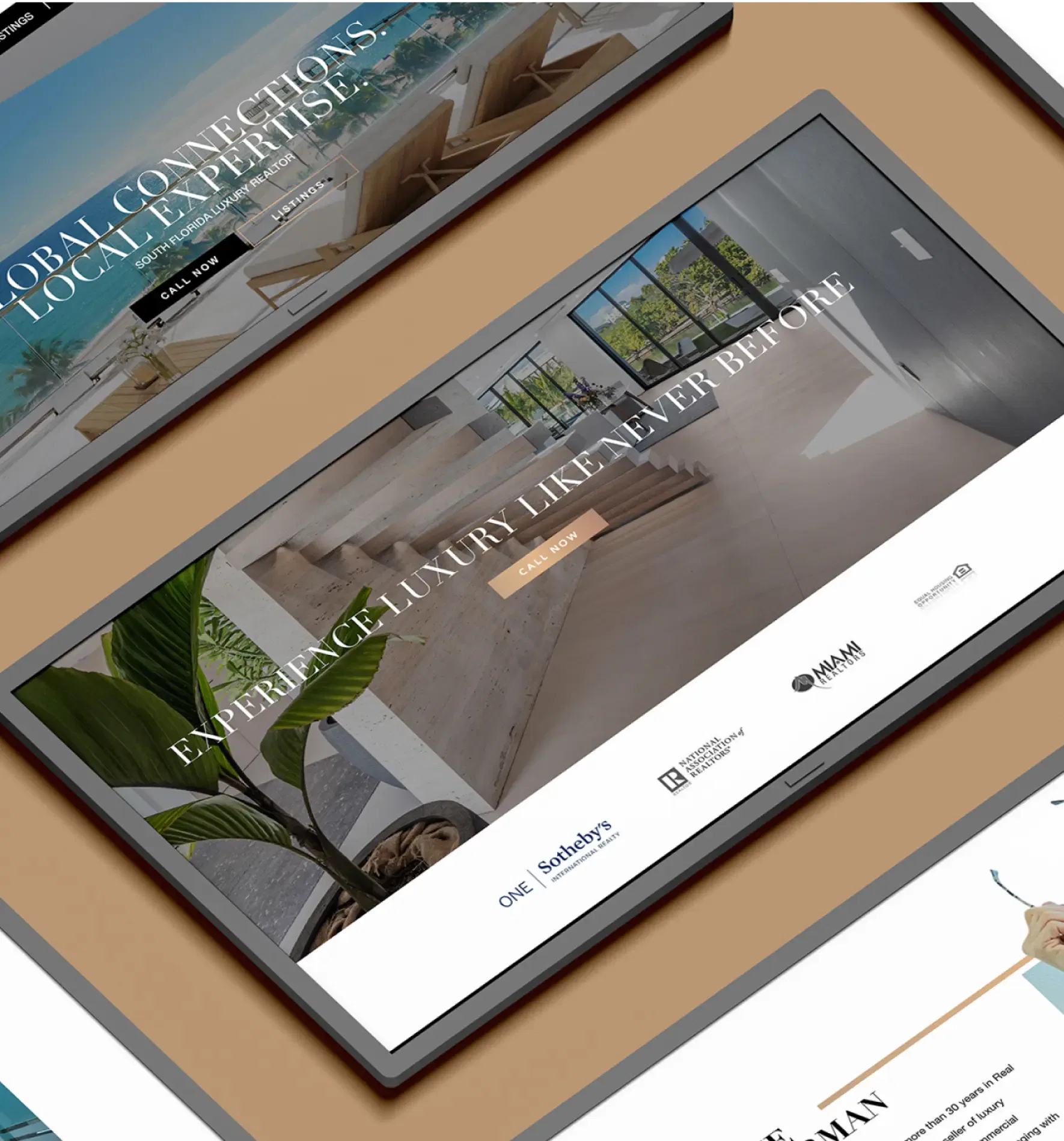 Digital tablet displaying a website with luxurious interior design and a modern interface on a brown background.