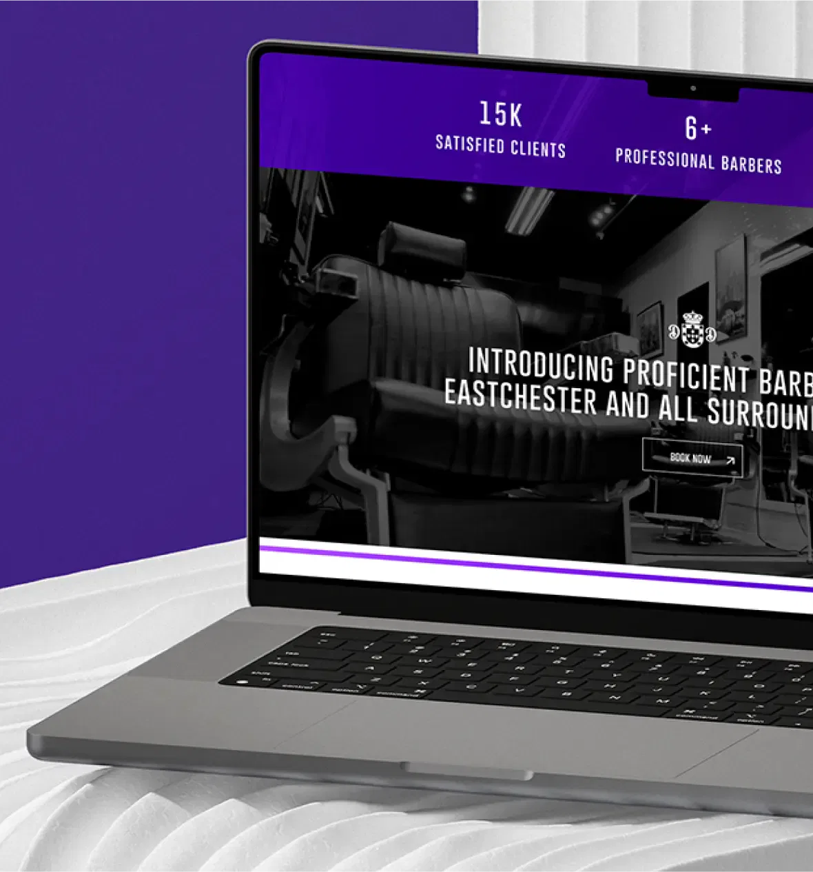 Laptop displaying a barbershop website with client and barber stats.