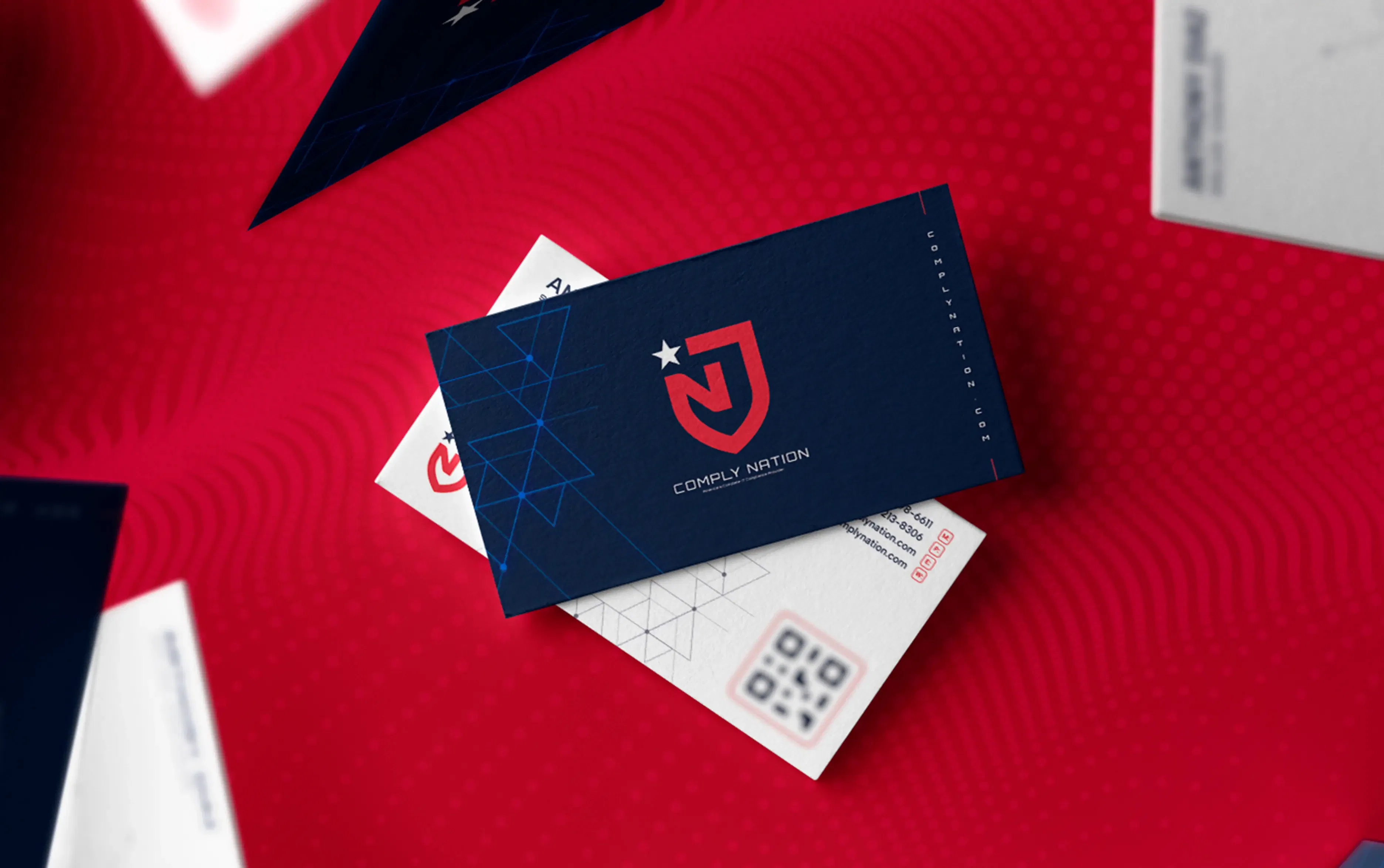 Navy blue business card with a bold red 'J' emblem on a vibrant red background.
