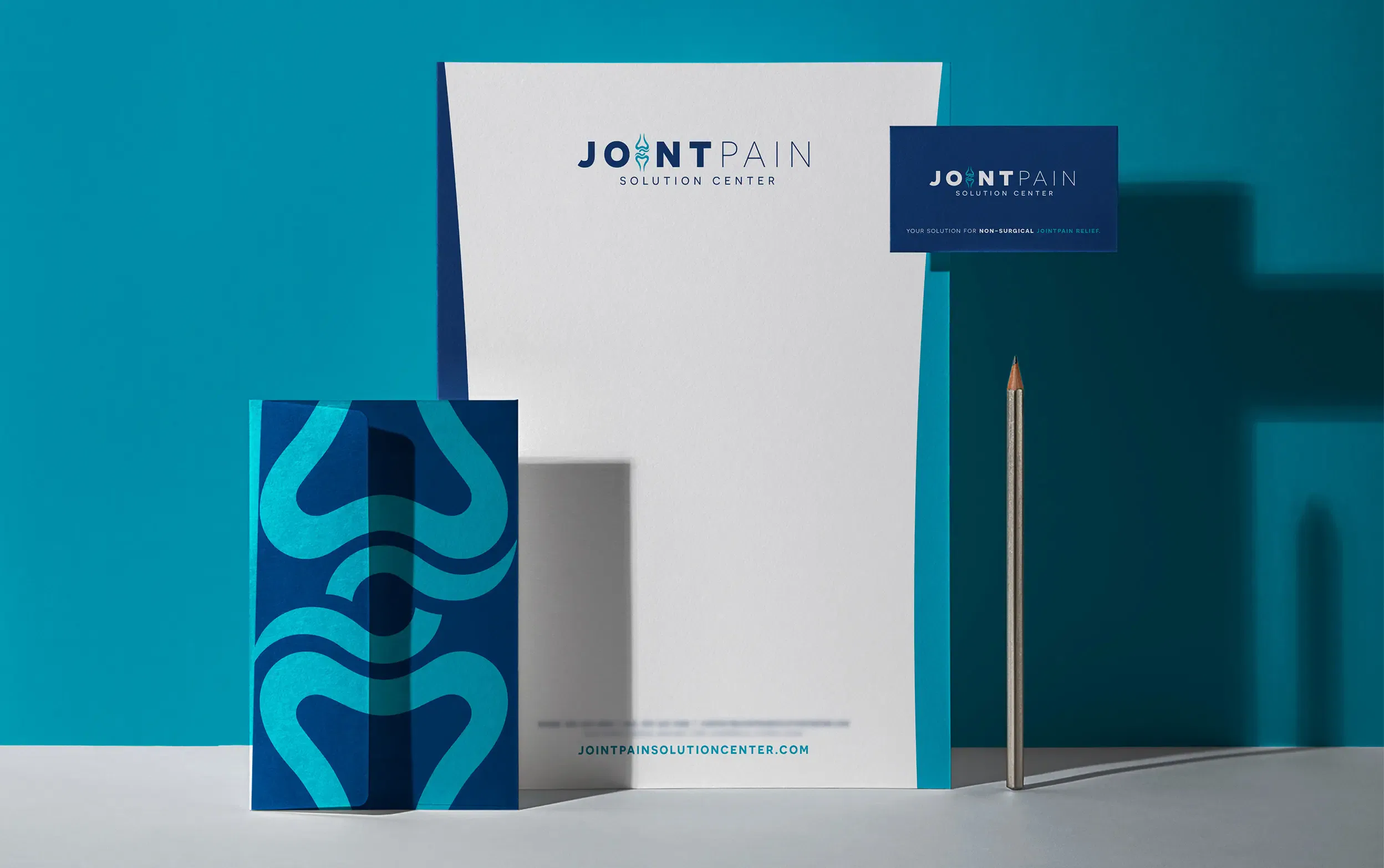 Joint Pain Relief branding materials including brochure, letterhead, and business card on a blue background.