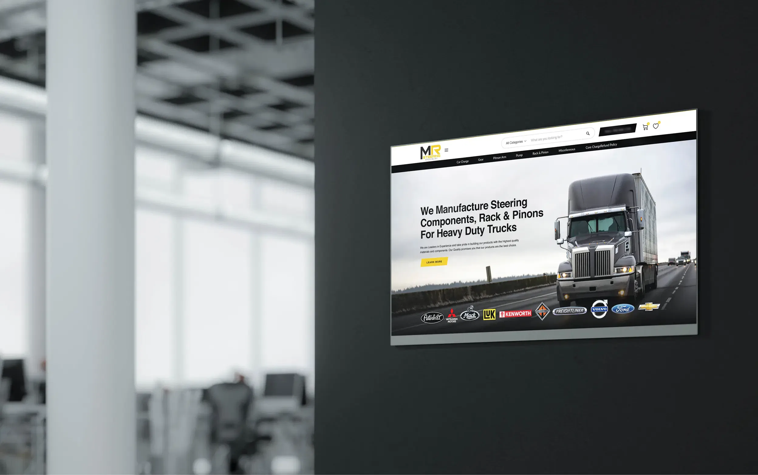 Office wall signage displaying a truck company's website.