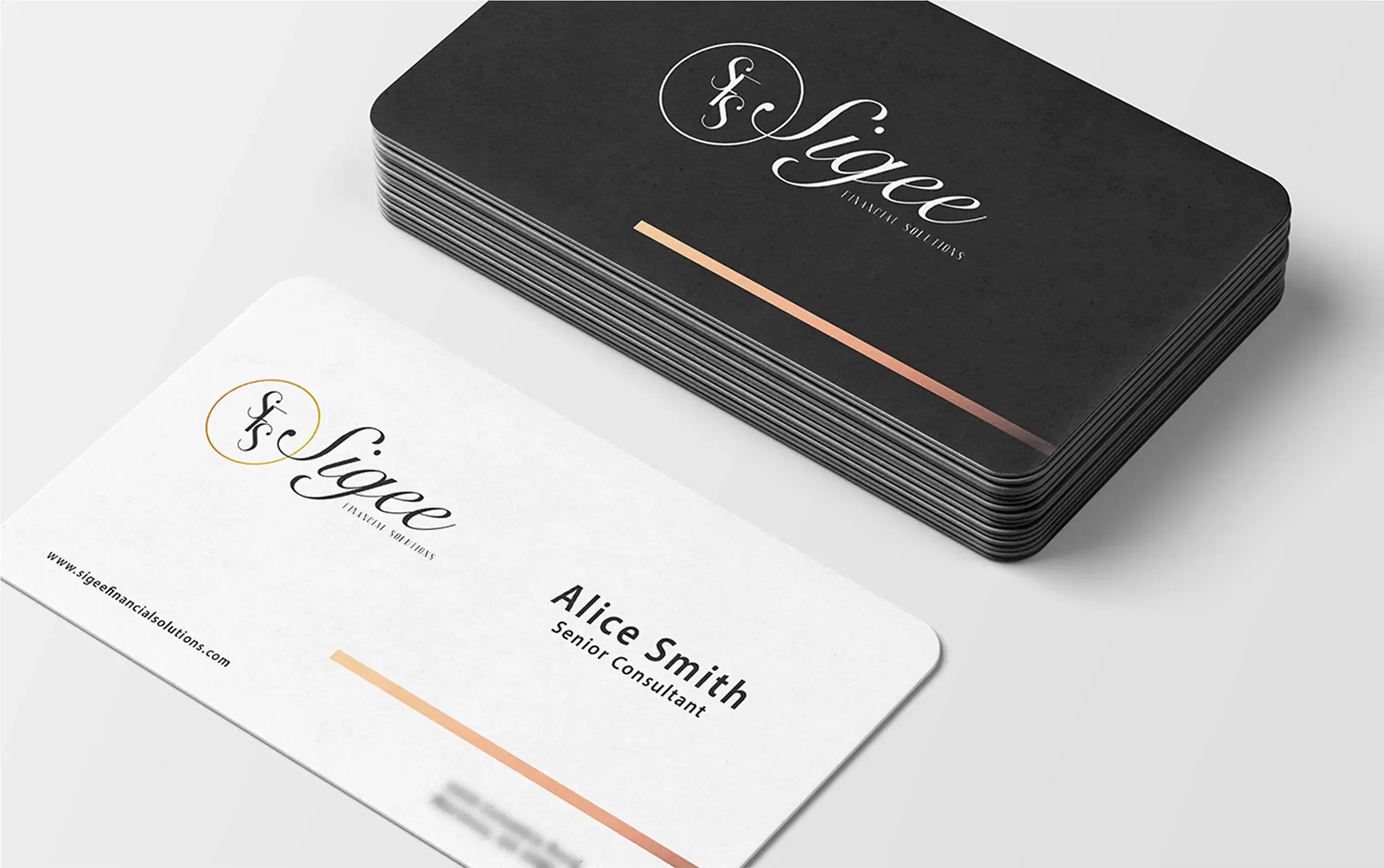 Stack of black and white business cards showcasing elegant branding with gold accents.