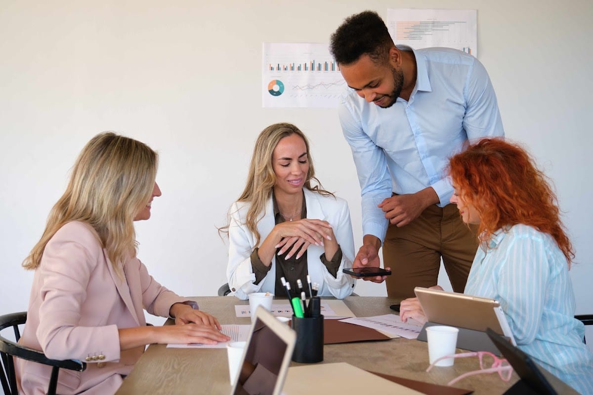 Diverse business team in a meeting with a leader presenting ideas.