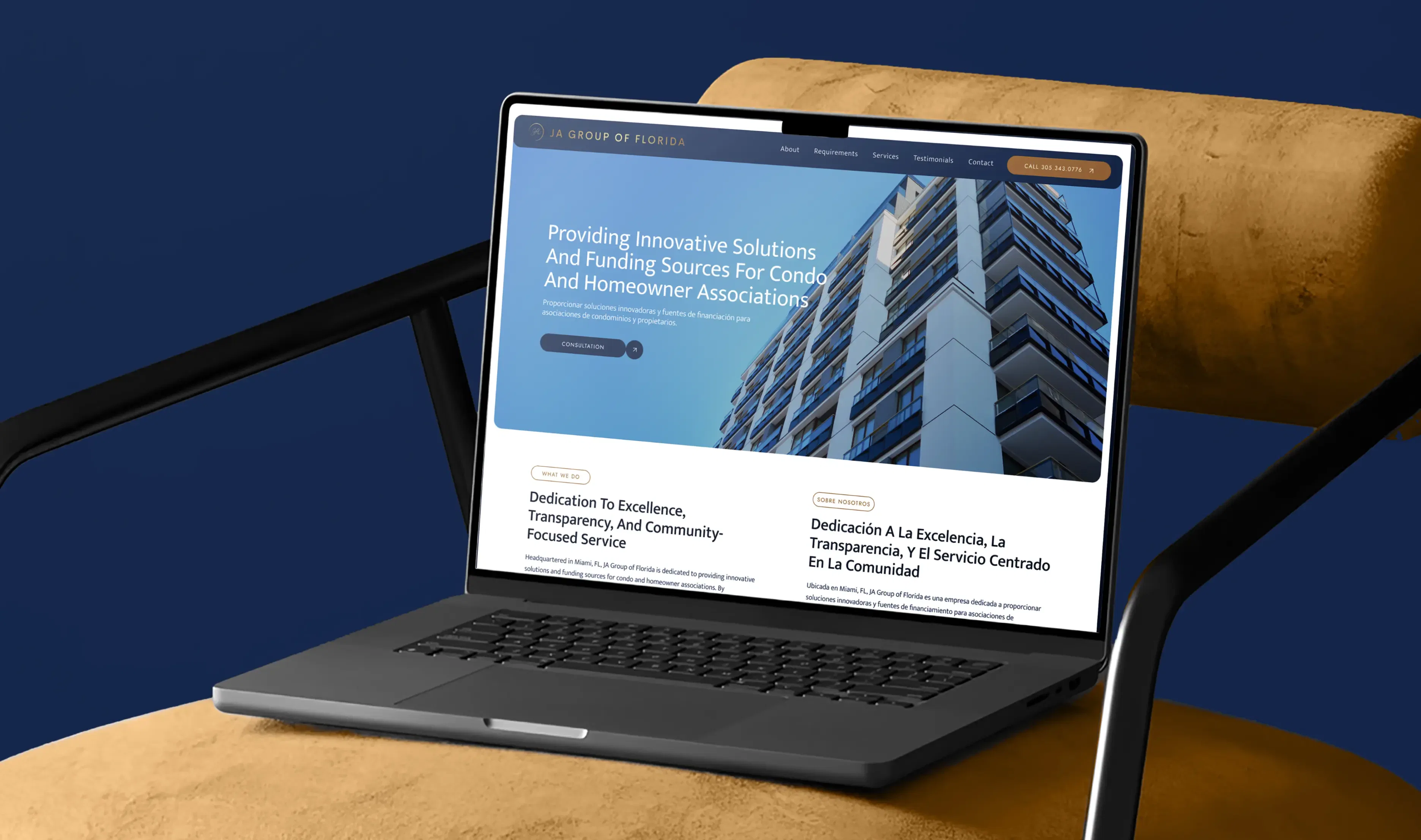 Laptop displaying a website with a modern high-rise building against a blue background.