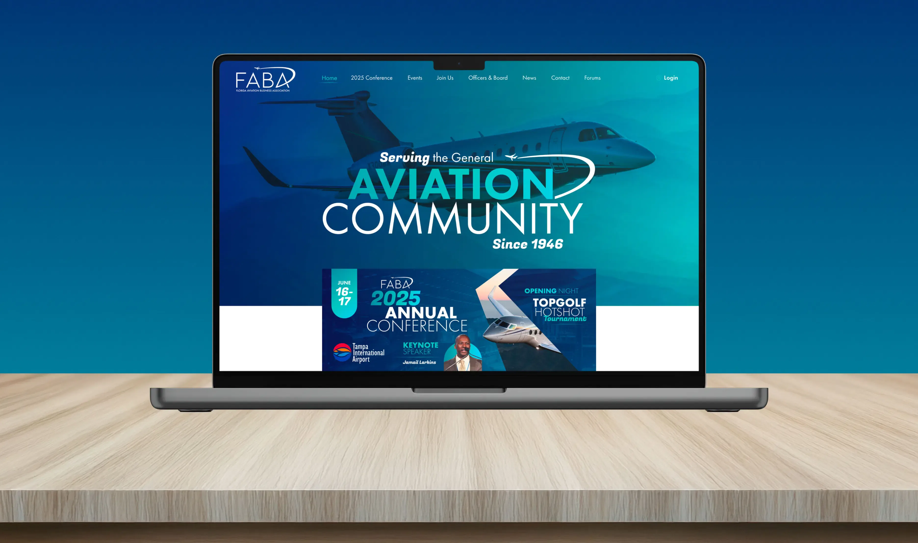 Laptop displaying an aviation community website on a wooden desk with a blue gradient background.