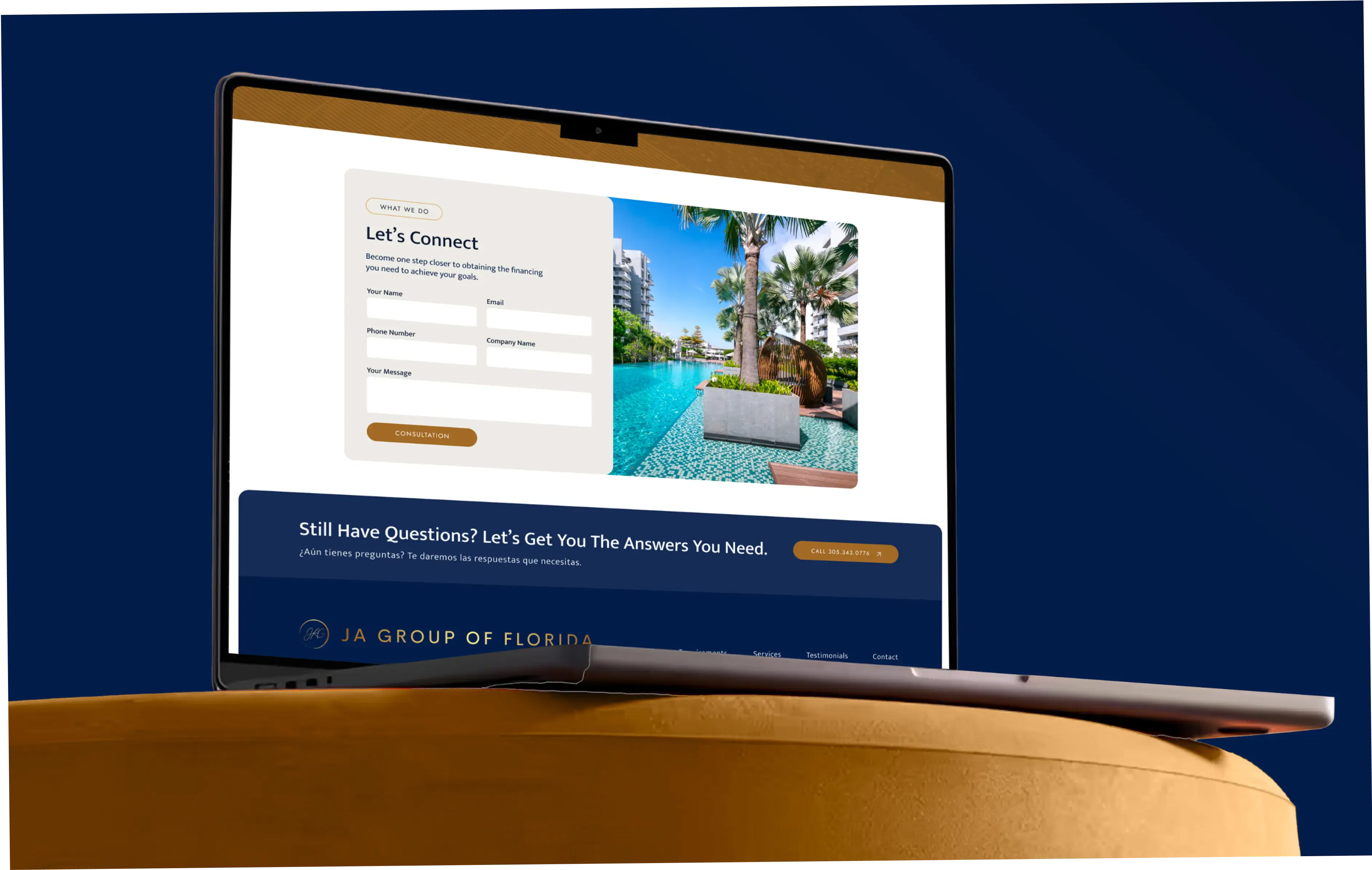 Laptop displaying a contact form with a luxury poolside view in the background.