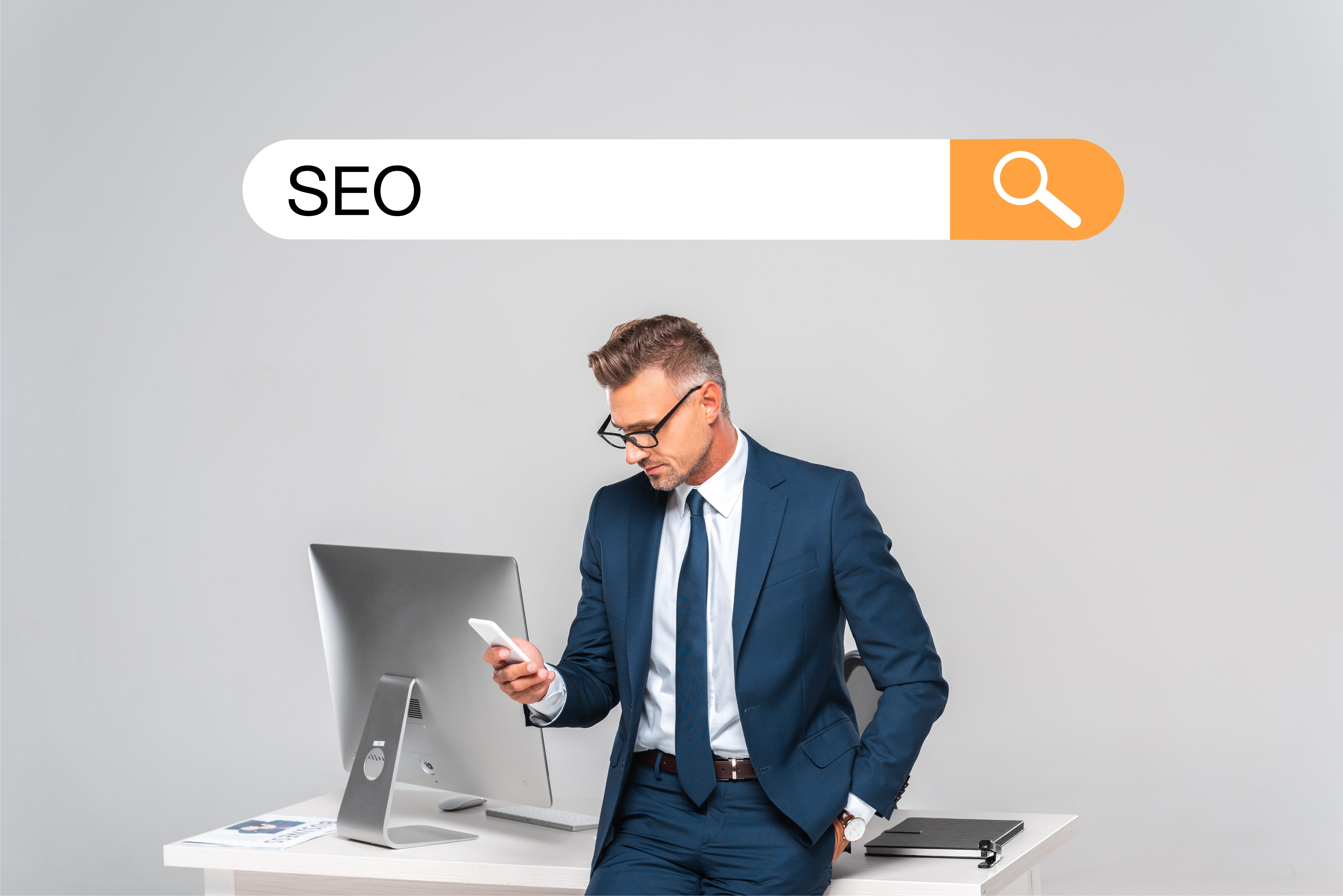 Man in suit using phone with SEO search bar