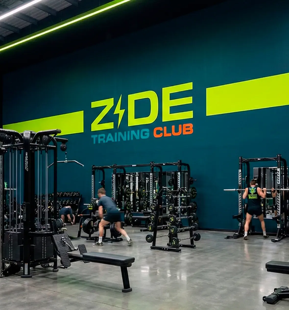 people lifting weights in gym training club